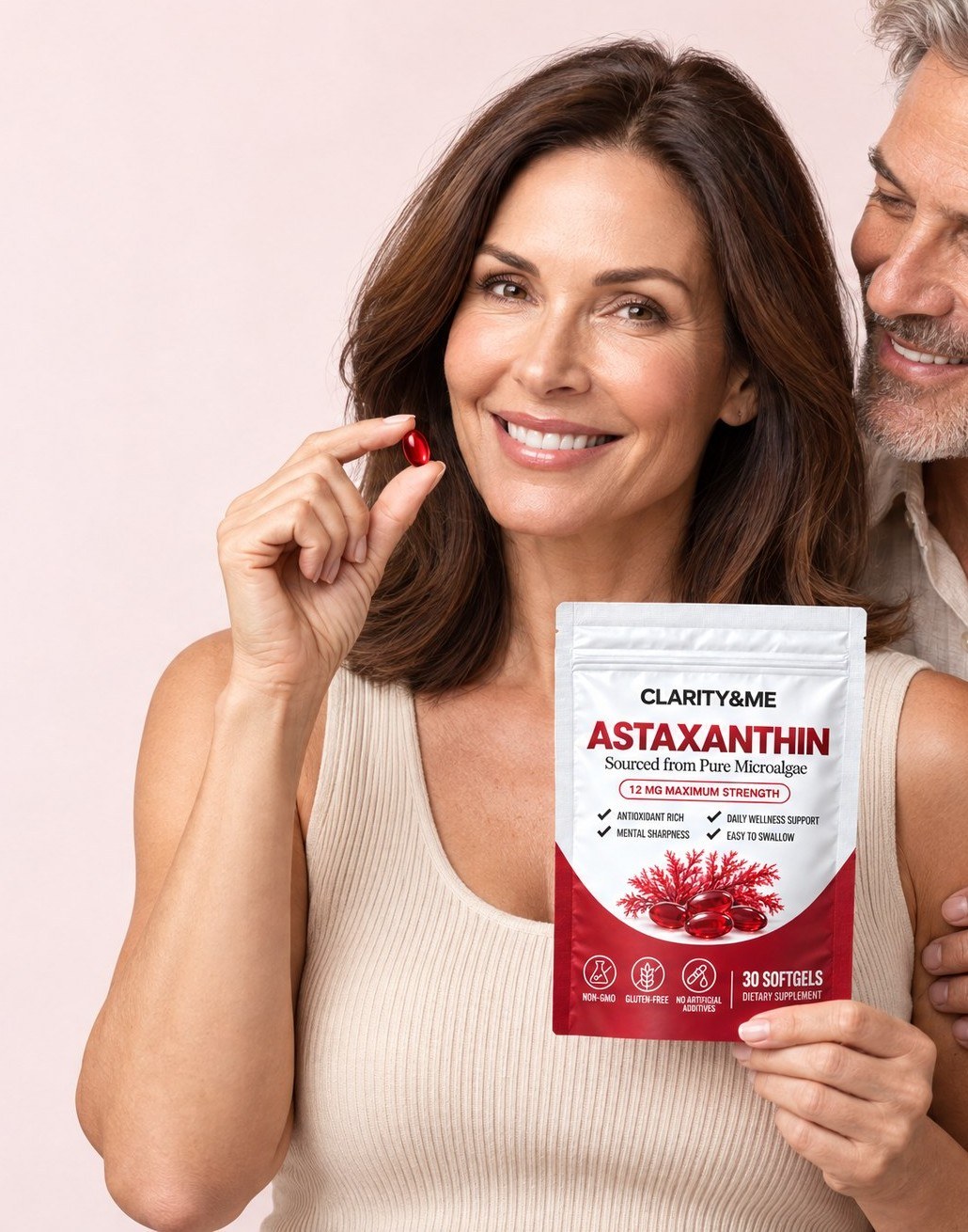 Woman holding Clarity&Me Astaxanthin and a red softgel